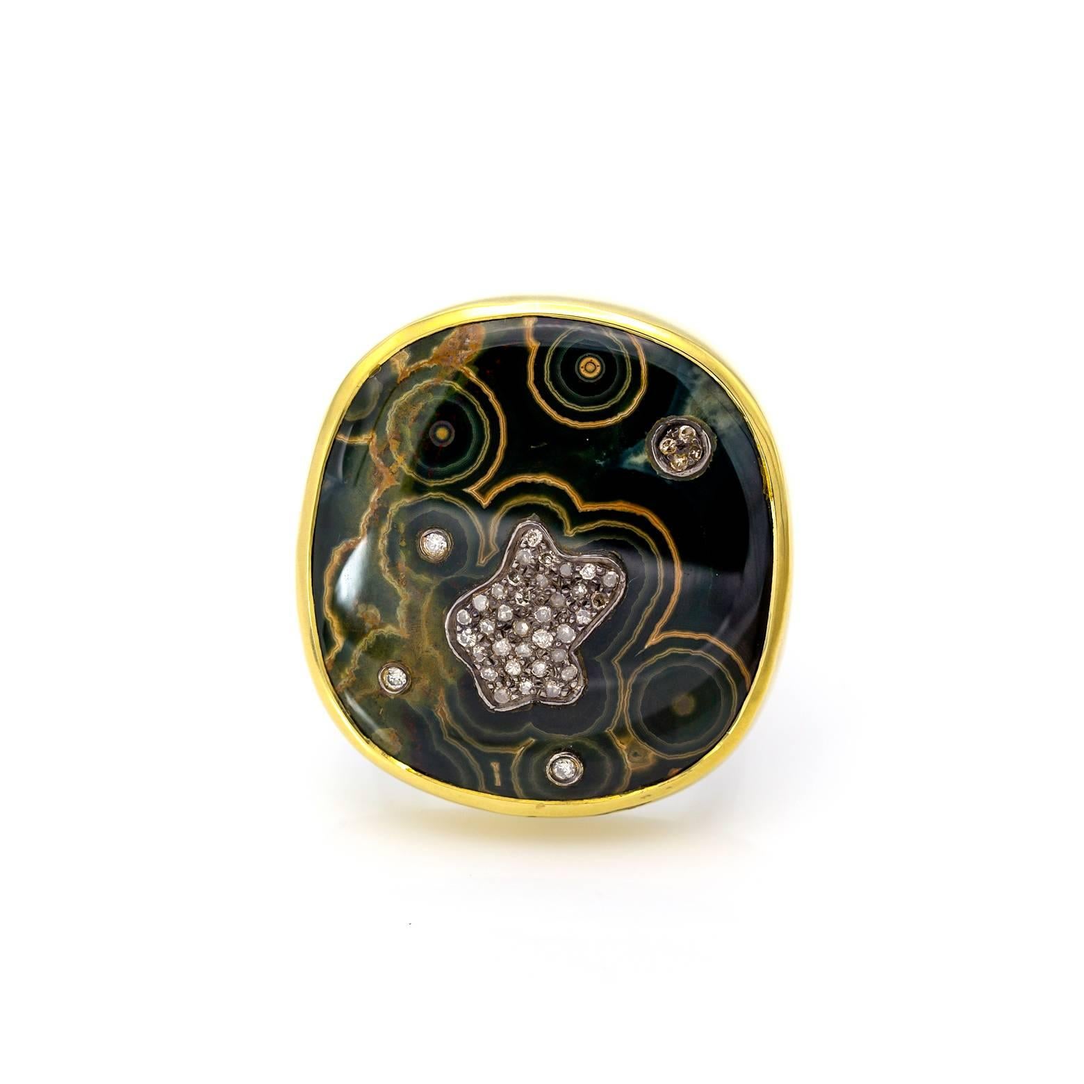 A statement ring of deep forest greens and natural concentric circles! This organic and natural ring is embellished with pave diamonds, an 18K yellow gold bezel and sterling silver band. A magical piece that brings the imagination into the depths of