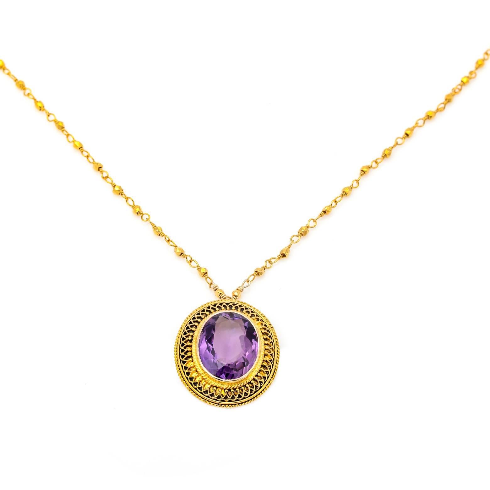 This stunning amethyst sparkles and dazzles in the light. The 14k gold setting has a filigree design that beautifully enhances the cut of the amethyst. The chain is 16 3/4