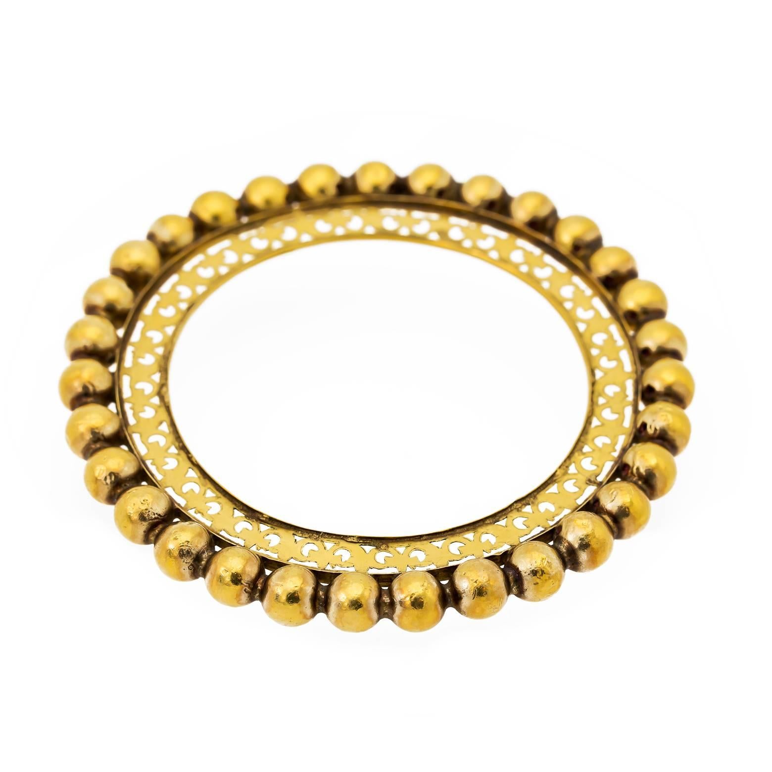 This substantial 18K yellow gold bangle Boho is finely detailed on the inside and has large gold spheres on the border. The inside circumference is meant for a smaller wrist and measures to 2.32 inches. Solid gold in the inner ring and the beads are