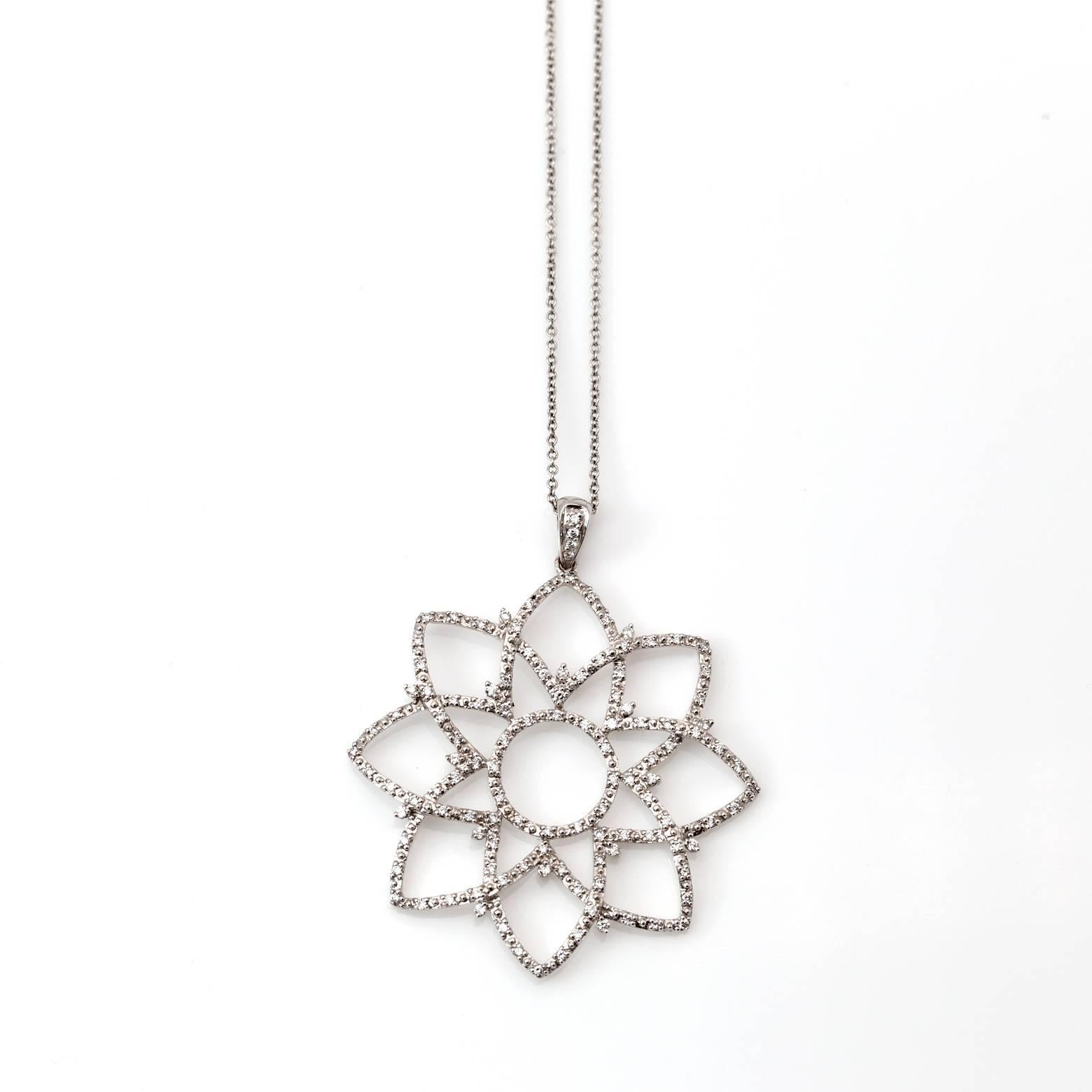 Sparkling white diamonds flicker and flare in this white gold flower pendant. A bridge between a flower and a star this beautiful pendant has a diamond total weight of 0.50 carats. Gorgeous and brilliant in a beautiful lotus design!