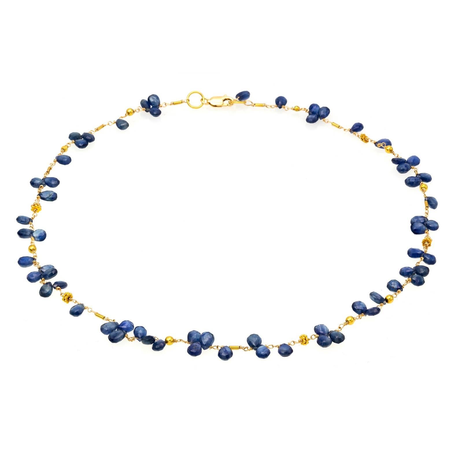 72 faceted blue sapphire briolettes create a delicate and feminine look with 18K yellow gold beads and chain. The blue sapphire beads looks like petals strung along a shiny golden path. Unique, artistic, one of a kind and the length is adjustable