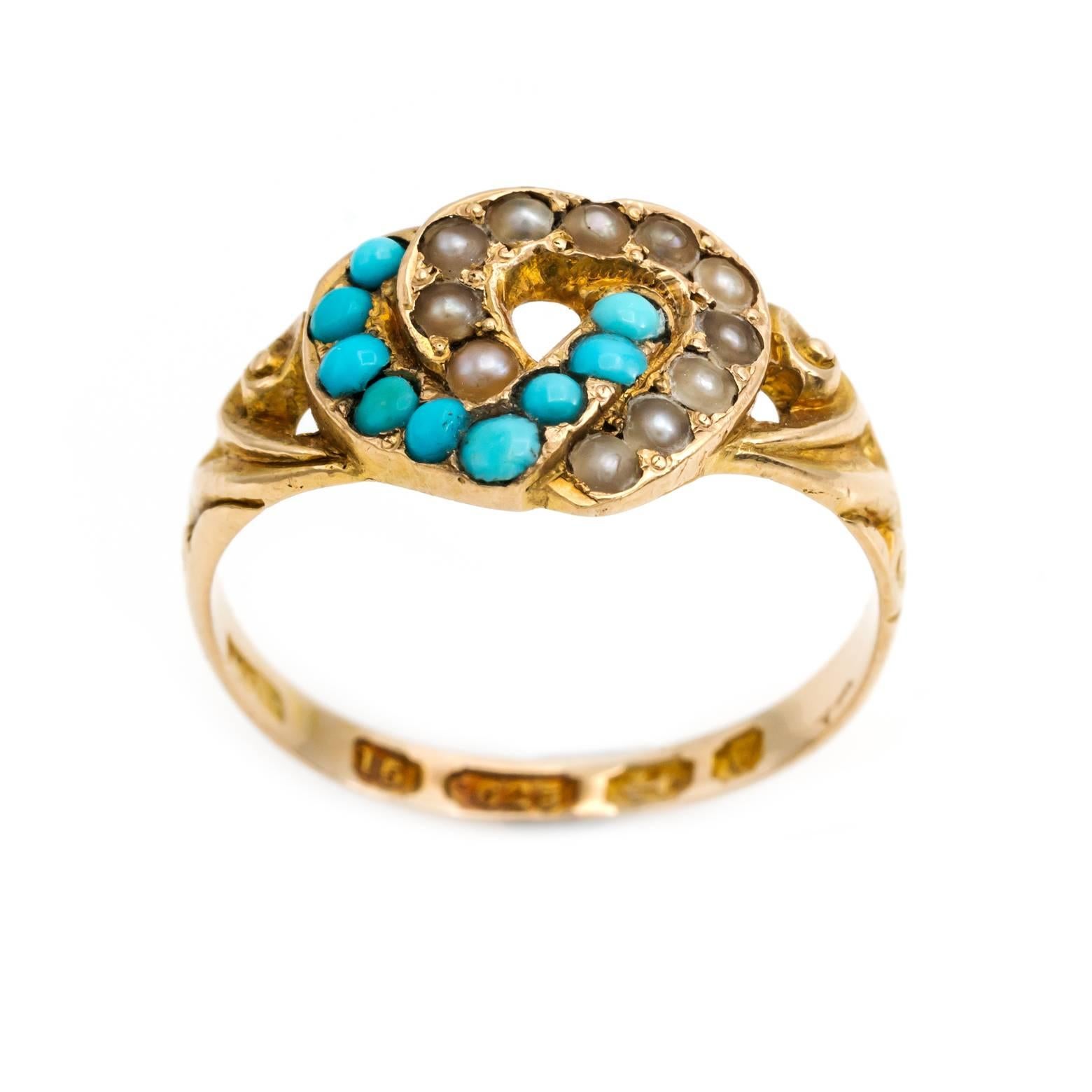 This sweet ring is two interlocking hearts of 15k gold. One of turquoise and one of pearls. The ring is a hallmarked Birmingham United Kingdom piece from 1871. A very special ring for that special someone. It is a size 5.