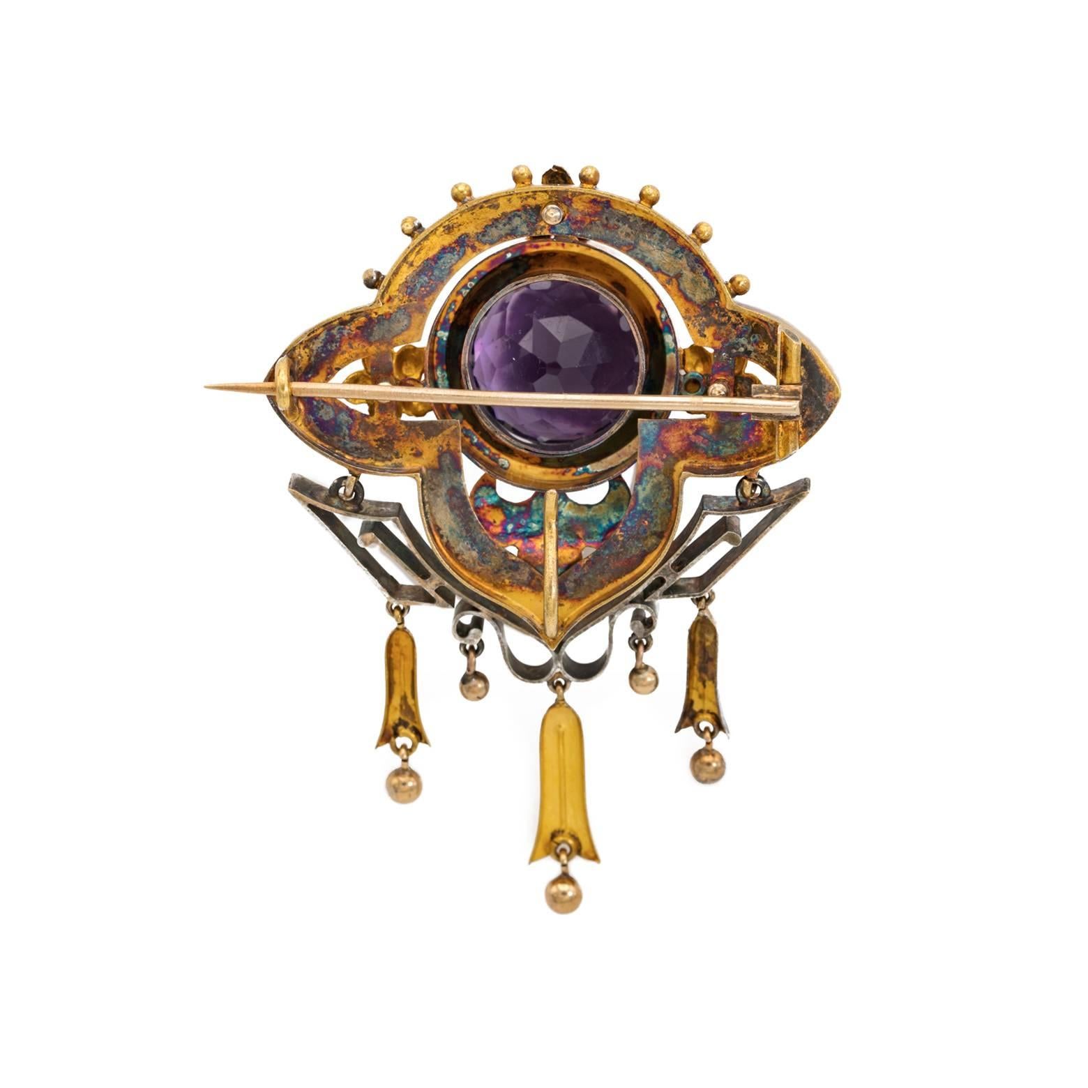 This unique and exquisite rose gold and amethyst brooch speaks volumes of history and art. The high copper content of the gold creates a beautiful rose gold with natural oxidation due to the antique age of over a hundred years. A large faceted round