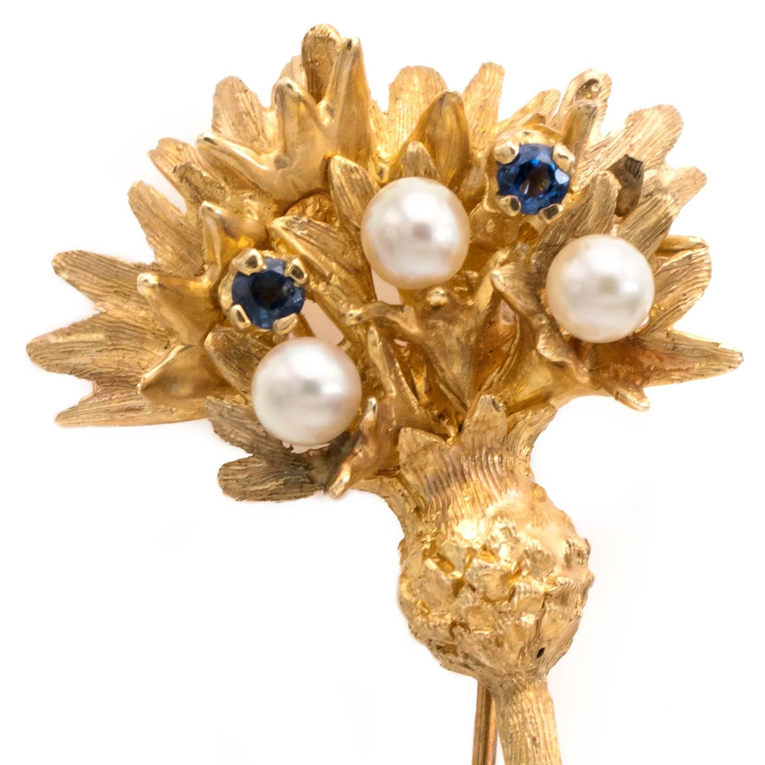 Botanical teasel Vintage brooch 14K yellow gold floral plant with 3 cultured pearl of 3 mm with 2 sapphires and 2 emeralds of 2 mm.
Stamped 14K IPS, matt finish on surface of the brooch.