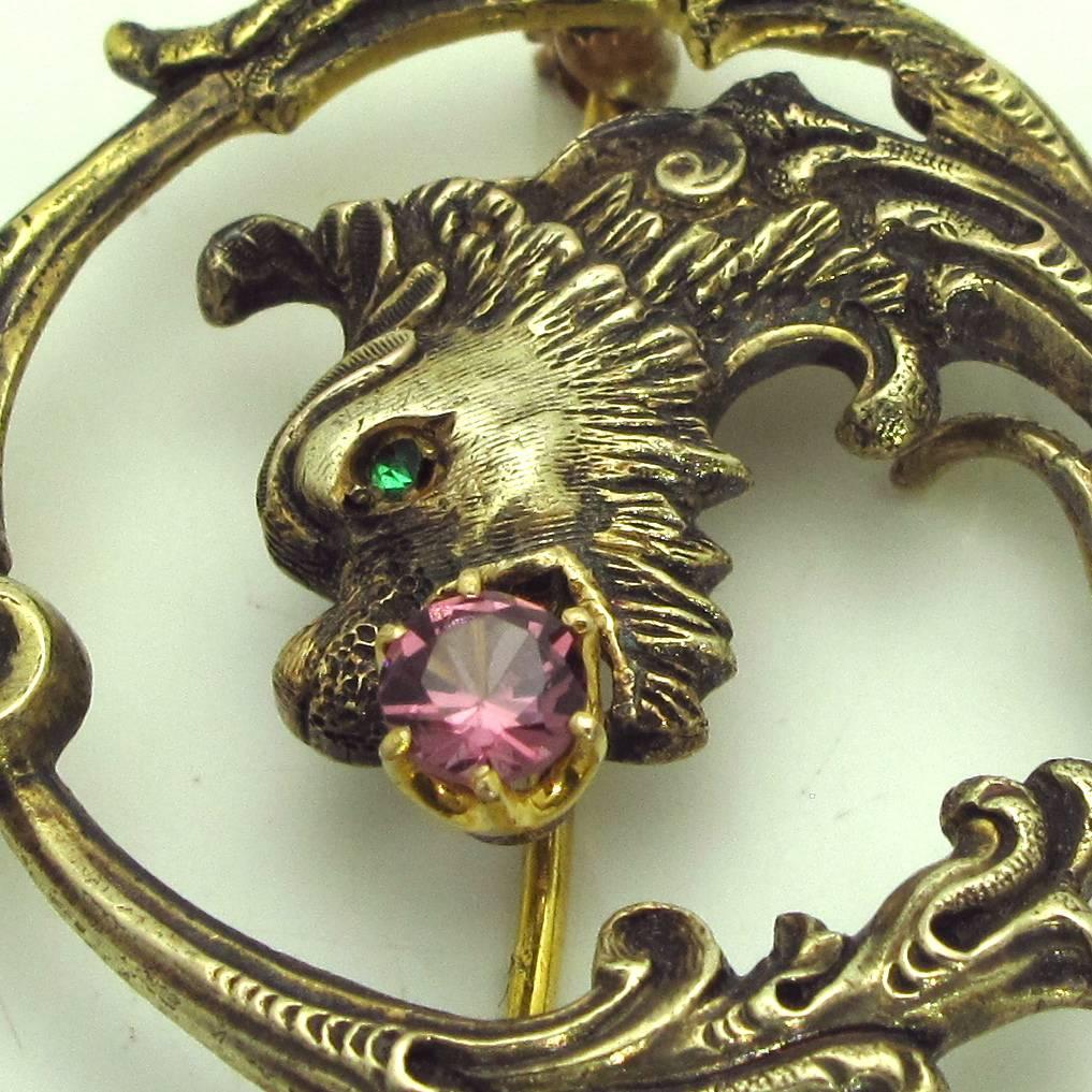 This 'fire' breathing dragon has a rubellite tourmaline in its mouth and an emerald eye.The combination of stones it accented by the antique finish on the gold. It is classic pin that you will wear always.