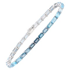 Bracelet tennis en or blanc 14 carats avec topazes bleues taille octogonale 5 x 3 mm, effet dégradé