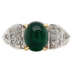 Emerald Cabochone Engagement ring with diamond studded gold planks. 