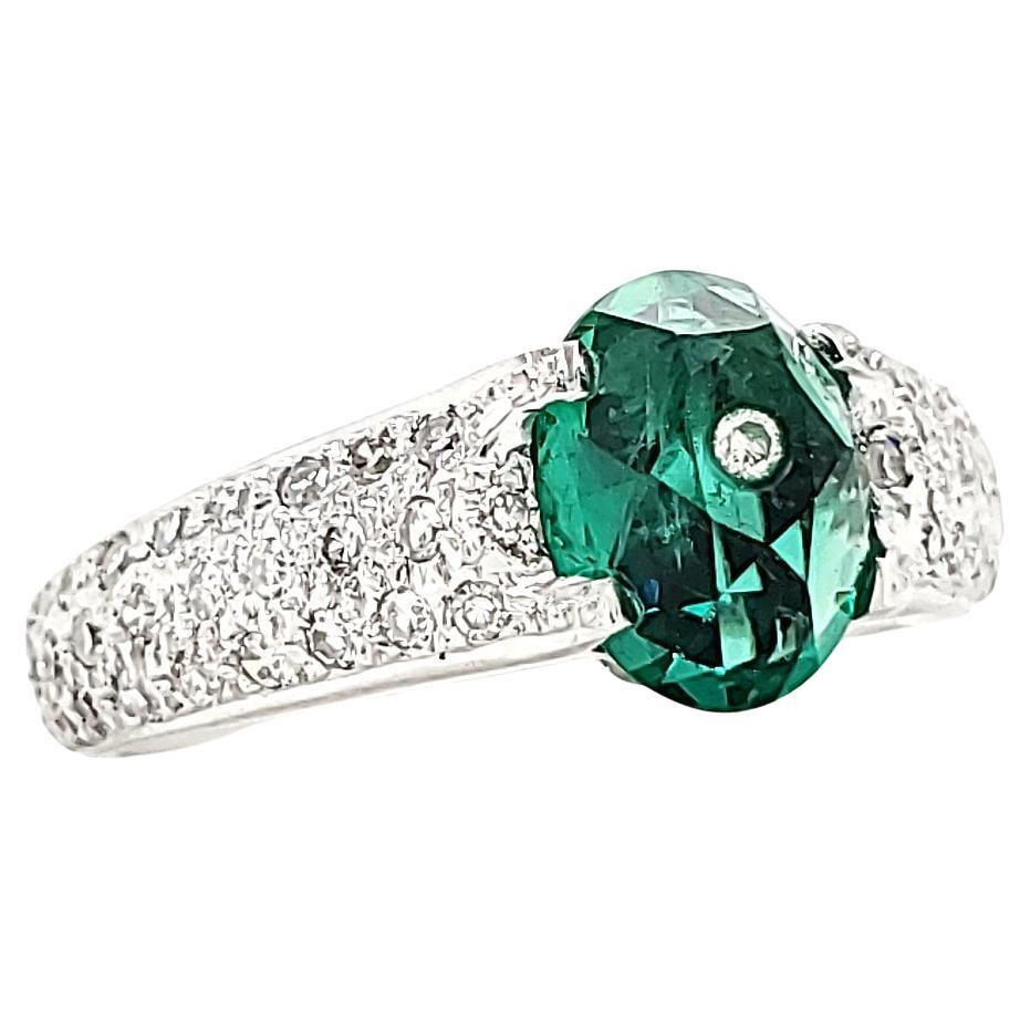 Behold this breathtaking 18k White Gold engagement ring, a masterpiece meticulously crafted to capture the essence of love and eternity. 

The dazzling centerpiece features a radiant 1.45-carat Oval Emerald embellished with a delicate diamond