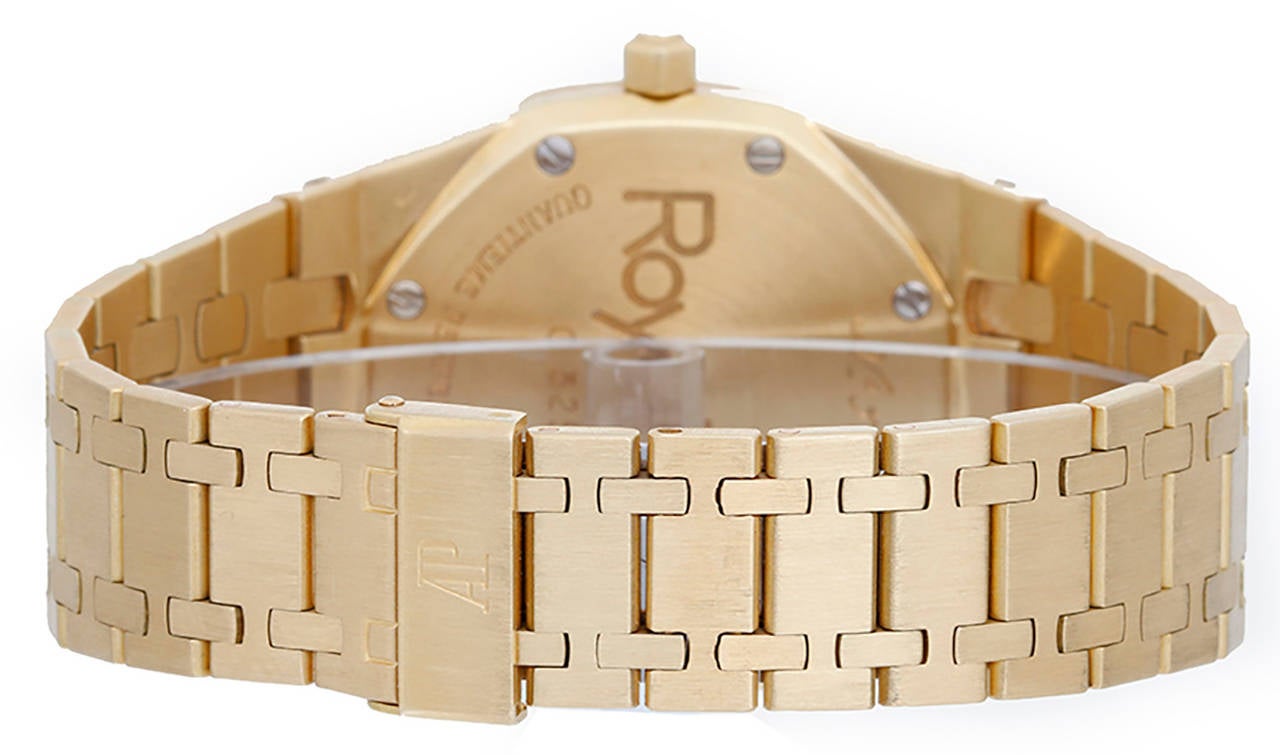 Automatic movement. 18k yellow gold case, 39mm diameter. Gilt dial with subsidiary dials for day, date, month and moonphase. 18k yellow gold Royal Oak bracelet, will fit apx. 7-inch wrist. Pre-owned with Audemars Piguet box and papers.