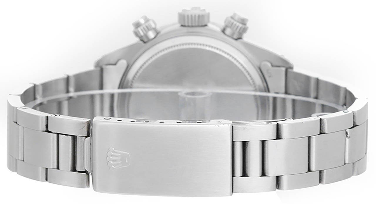 Manual-wind chronograph movement. Stainless steel case with rotating bezel with black insert, 38mm diameter. Silvered dial with black sub dials and Daytona in red letters. Stainless steel Oyster bracelet. Serial number 6198348. Pre-owned with box.