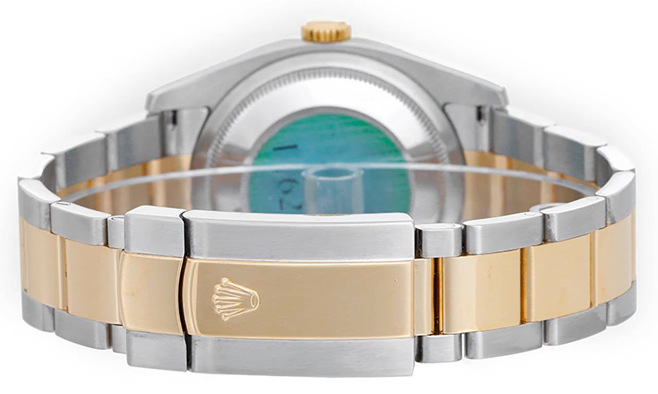 Automatic winding, 31 jewels, Quickset, sapphire crystal. Stainless steel case with 18k yellow gold smooth bezel (36mm diameter). Ivory Pyramid dial with fold Roman numerals. Stainless steel and 18k yellow gold Oyster bracelet. Pre-owned with box.