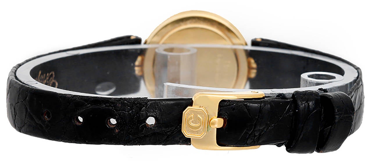 Quartz. 18k yellow gold case (20mm diameter). Black with 3 floating diamonds and gold center. Black croc strap band with gold plaque Chopard buckle. Pre-owned with papers.