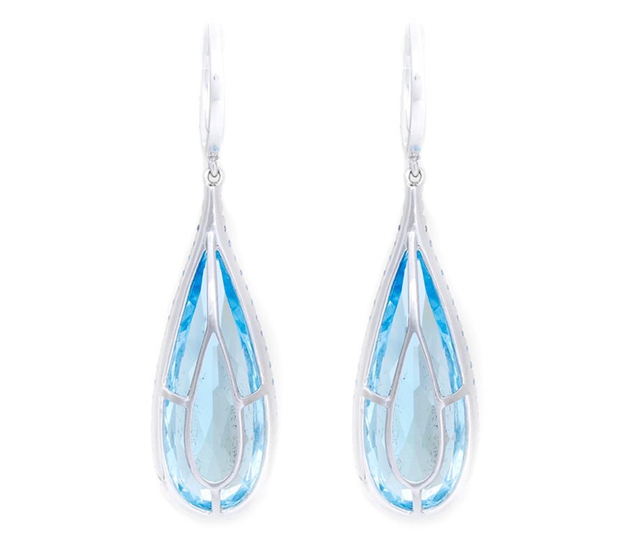These earrings feature 29 carats of blue topaz and 1.82 carats of sapphires. They measure 2 inches in length and 1/2 inch at the widest point. They weigh 12.8 grams. A very fun piece for a reasonable price.
