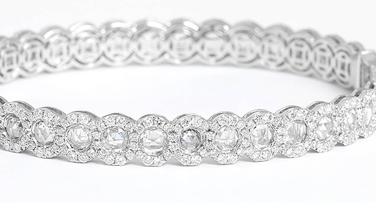 This beautiful bracelet features  5.15 carats of rose cut diamonds each bordered by 3.15 carats of round brilliant cut diamonds. Diamonds are VS clarity and E color. The bracelet measures apx. 1/4-inch in width and fits apx. a 7-inch wrist. Total
