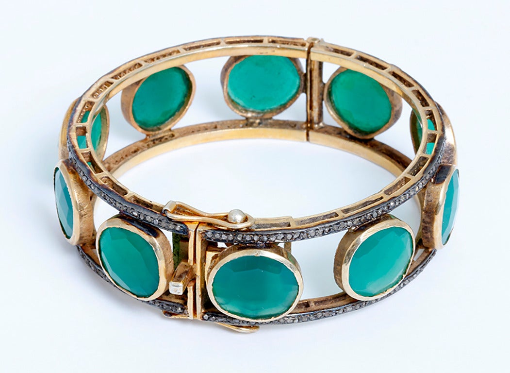 This beautiful bracelet features 50.6 carats of green onyx and 2.4 carats of diamonds set in  silver, yellow gold plated. The bracelet measures apx. 3/4-inch in width and fits apx. a 7-inch wrist. Total weight is 53 grams. This bracelet is the