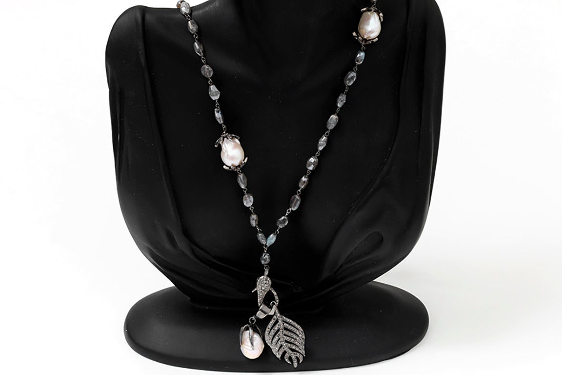 This amazing necklace features baroque pearls,  0.88 carats of diamonds, and a hematite beaded  chain. Attached are two dangle pendants featuring a diamond feather dangle with a  baroque pearl and diamond dangle.   The chain measures apx. 38-inches