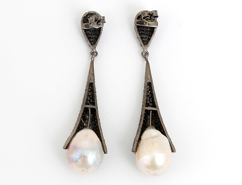 These beautiful claw earrings feature 3.5 carats of diamonds and baroque pearls set in  silver. The drop measures apx. 2-1/4 inches in length. Total weight is 25.4 grams. These earrings are great for any occasion!