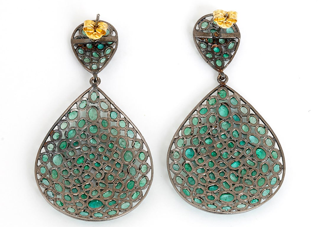 These amazing earrings feature apx. 6.5 carats of emeralds set in silver. The earring drop measures apx. 1-3/4 inch in length and 1-1/4 inches at the widest. Total weight is 13.8 grams. These earrings are great for any look!