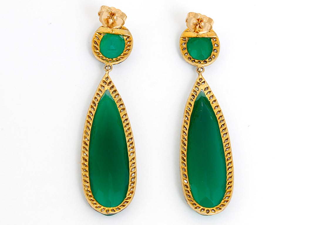 These amazing earrings feature an oval and teardrop shaped green onyx bordered by 3.03 carats of diamonds set in oxidized  silver, 14k yellow gold plated. The earrings measure apx. 3-inches in length. Total weight is 23 grams.