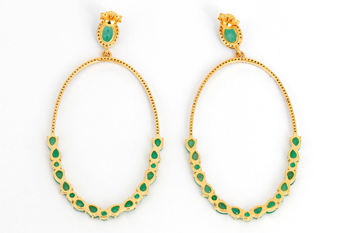 These beautiful earrings feature emeralds and 0.55 carats of diamonds set in 18k yellow gold. The drop measures apx. 2-inches in length and 1-1/8 inches at the widest. Total weight is 7.1 grams. These earrings are light and comfortable to wear!