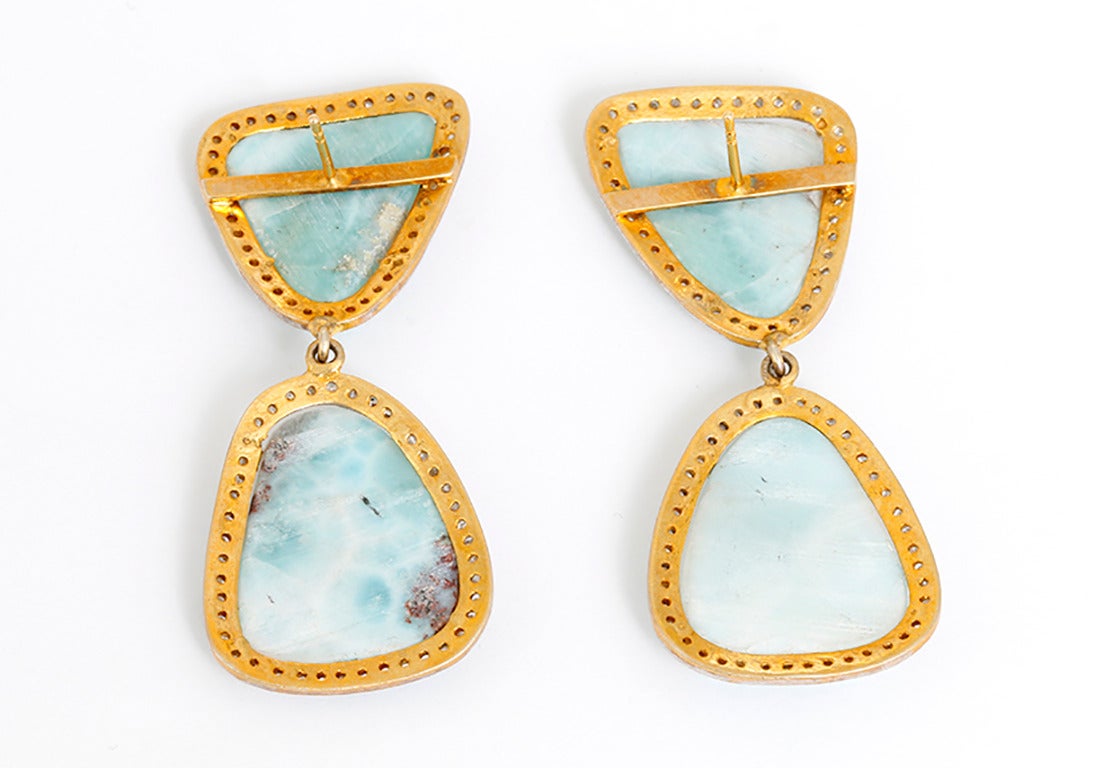 These beautiful earrings feature larimar stones surrounded by 2.25 carats of diamonds set in silver, yellow gold plated. They are apx. 2-1/8 inches in length. Total weight is 18.3 grams. These earrings are great for any look!
