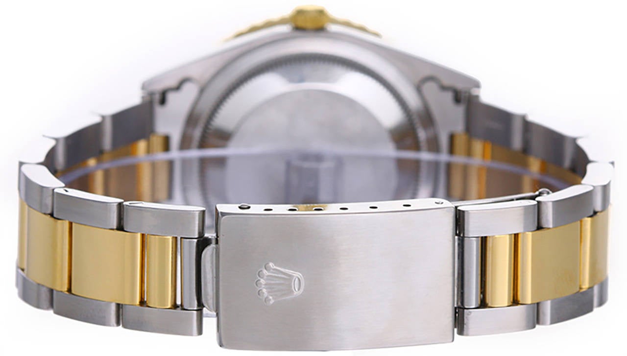 Automatic winding with date; sapphire crystal. Stainless steel case with 18k yellow gold rotating Thunderbird bezel  (36mm diameter). Genuine Rolex steel Serti diamond dial. Stainless steel and 18k yellow gold Rolex Oyster bracelet. Pre-owned with