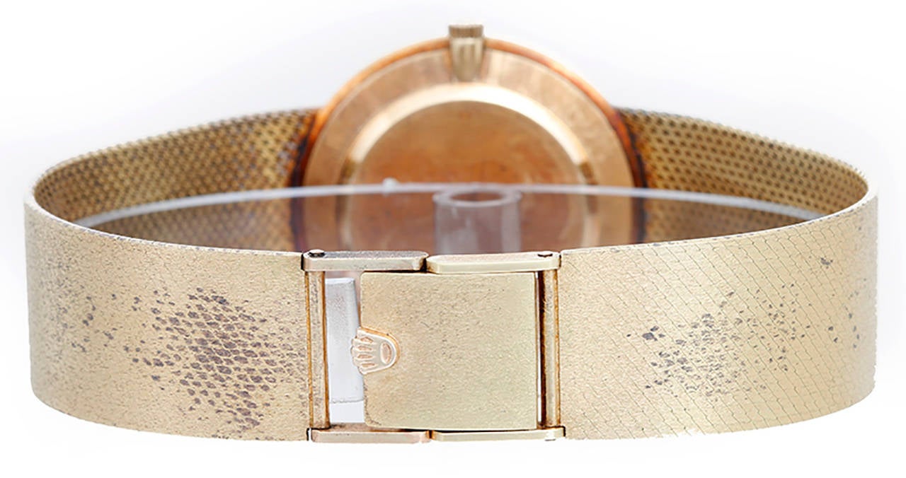 Manual winding. 14k yellow gold case (31mm diameter). Gray dial with gold stick markers. Integrated 14k yellow gold mesh bracelet (will fit apx. 7-1/4 inch wrist). Pre-owned with custom box. Ca. 1950's/60's  Total weight, including movement and