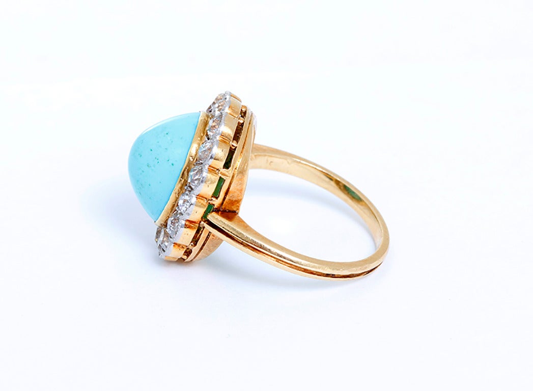 This stunning antique ring features an oval turquoise cabochon (apx. 11.2 mm x apx. 9.0mm x apx.  6.3mm) bordered by 16 old-mine cut diamonds at apx. 0.60 carats. Diamonds are I-J-K in color and VS-SI in clarity.   Ring is size 4-3/4. Total weight
