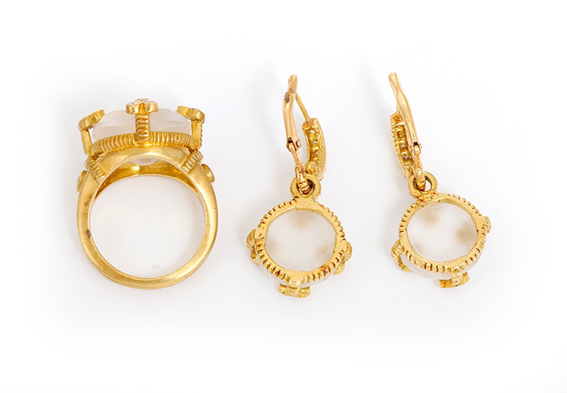 This beautiful set features rock crystal and diamonds set in 18k yellow gold. Ring is size 5-3/4;  measures apx. 3/4-inch in width and apx.  5/8-inch in length. Earrings measure apx. 1-1/8 inches in length.