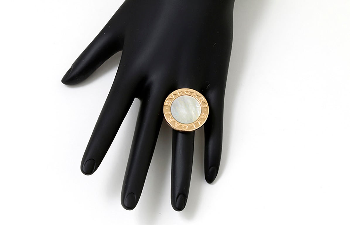 This amazing  Bulgari ring features mother-of-pearl set in 18k yellow gold. Signed Bulgari. The ring measures apx. 15/16-inch in diameter with a total weight of 14.8 grams.