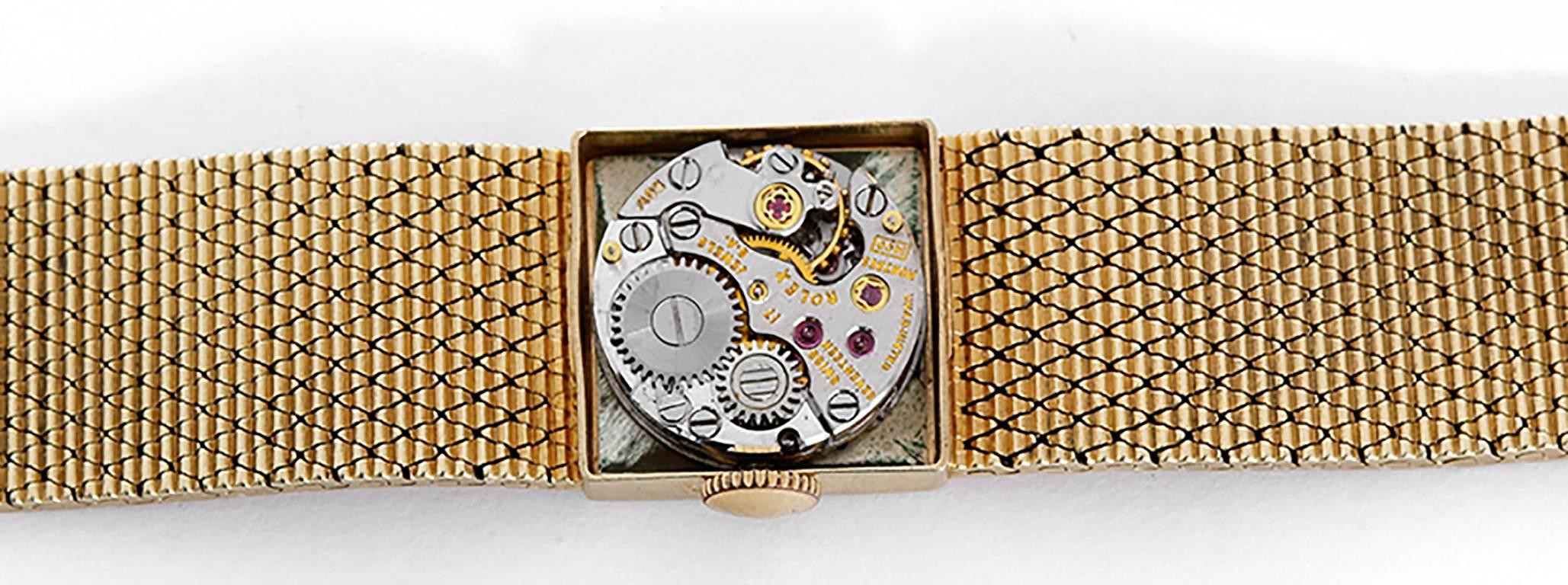 Manual winding. 14k yellow gold case (15mm x 15mm). Silvered dial with stick markers. 14k yellow gold integrated mesh bracelet with Rolex crown on clasp (will fit apx. 5-1/2 in. wrist). Pre-owned with custom box.