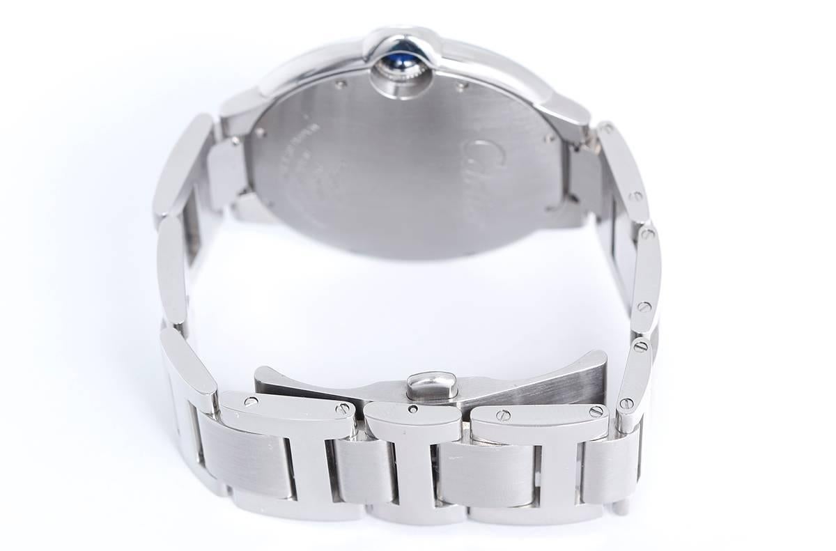 Cartier Ballon Bleu Men's 42mm Stainless Steel Automatic Watch W69012Z4 -  Automatic winding. Stainless steel case (42mm diameter). Silver guilloche dial with black Roman numerals; date at 3 o'clock. Stainless steel Cartier bracelet with deployant