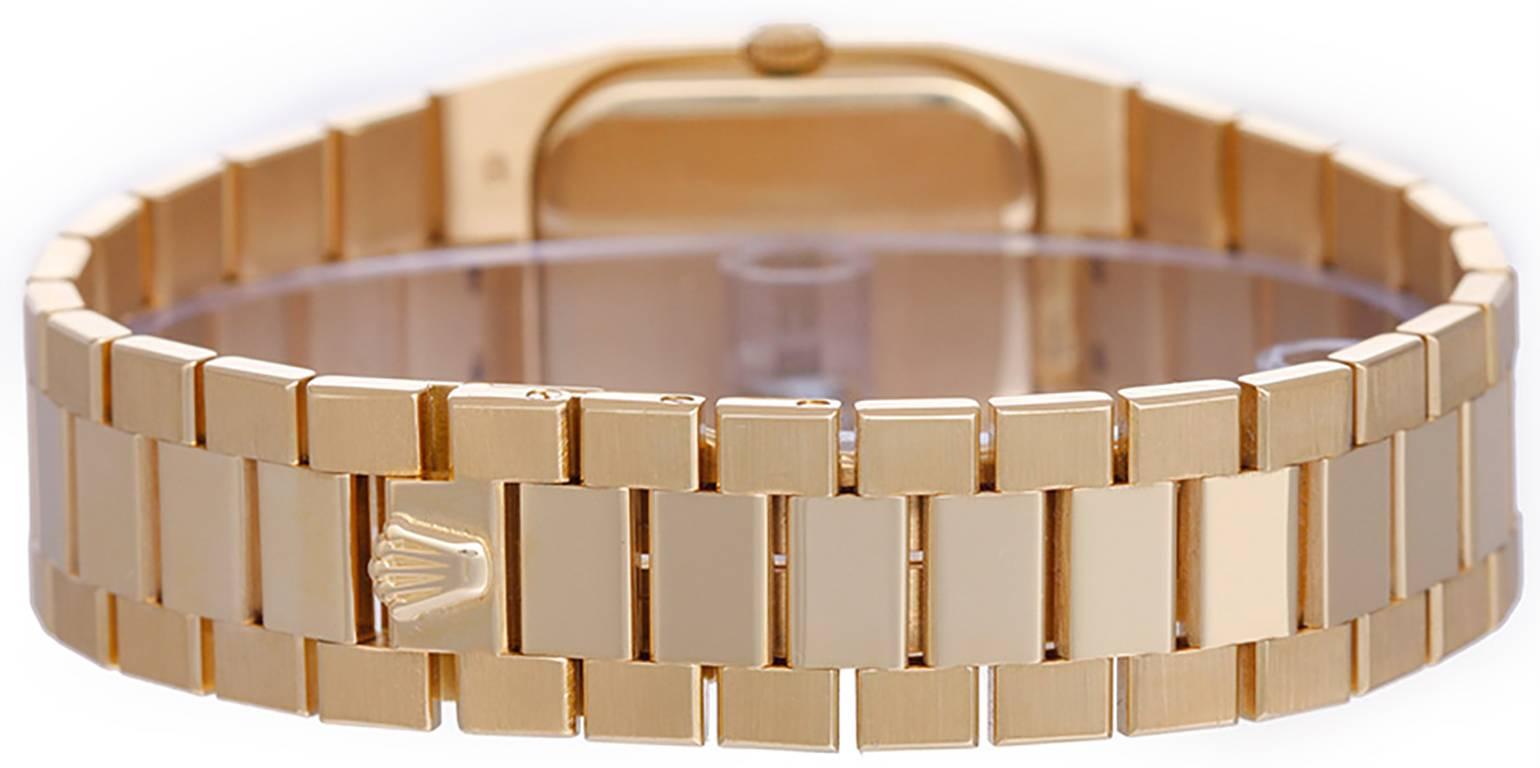 Quartz. 18k yellow gold case with octagon shaped diamond bezel (27mm x 34mm). Gold colored dial. 18k yellow gold tapered bracelet with polished center links. Pre-owned with Rolex box.
