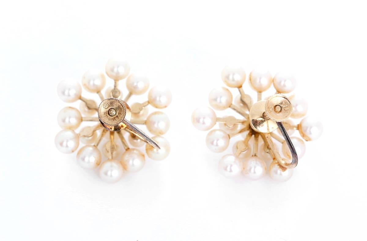 These amazing vintage non-pierced earrings feature pearls in 14k yellow gold. Earrings measure apx. 7/8-inch in diameter. Total weight is 9.1 grams.
