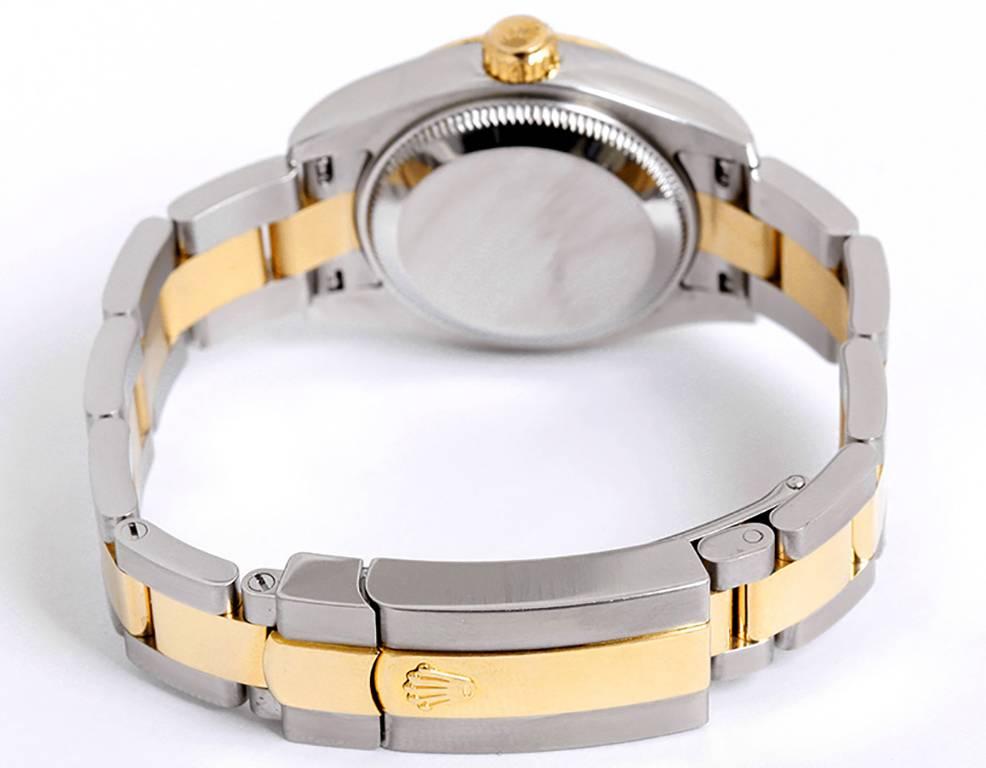 Automatic winding, Quickset, 31 jewels, sapphire crystal. Stainless steel case with 18k yellow gold fluted bezel (26mm diameter). Champagne Jubilee dial with factory diamond hour markers. Stainless steel and 18k yellow gold Oyster bracelet.