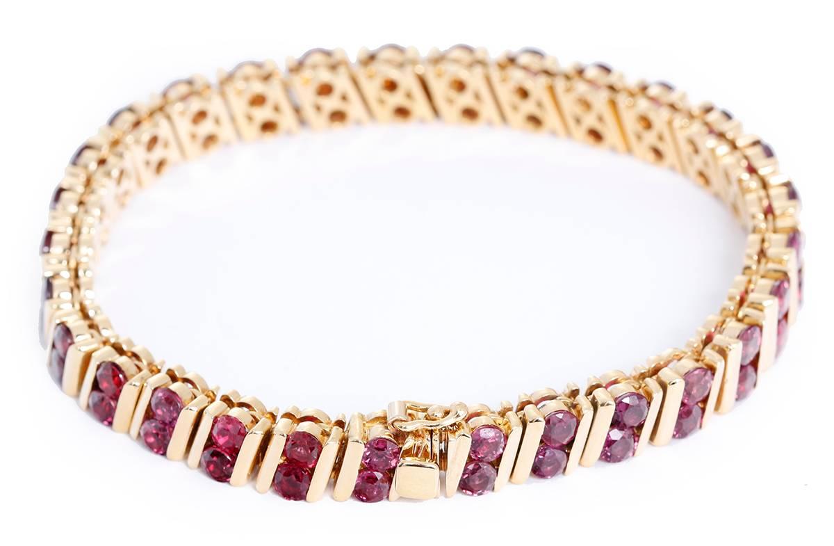This amazing Tiffany & Co. bracelet features apx. 10 carats of rubies set in 18k yellow gold. Bracelet measures apx. 7-inches in length. Total weight is 37.6 grams. Signed, TIFFANY 18k