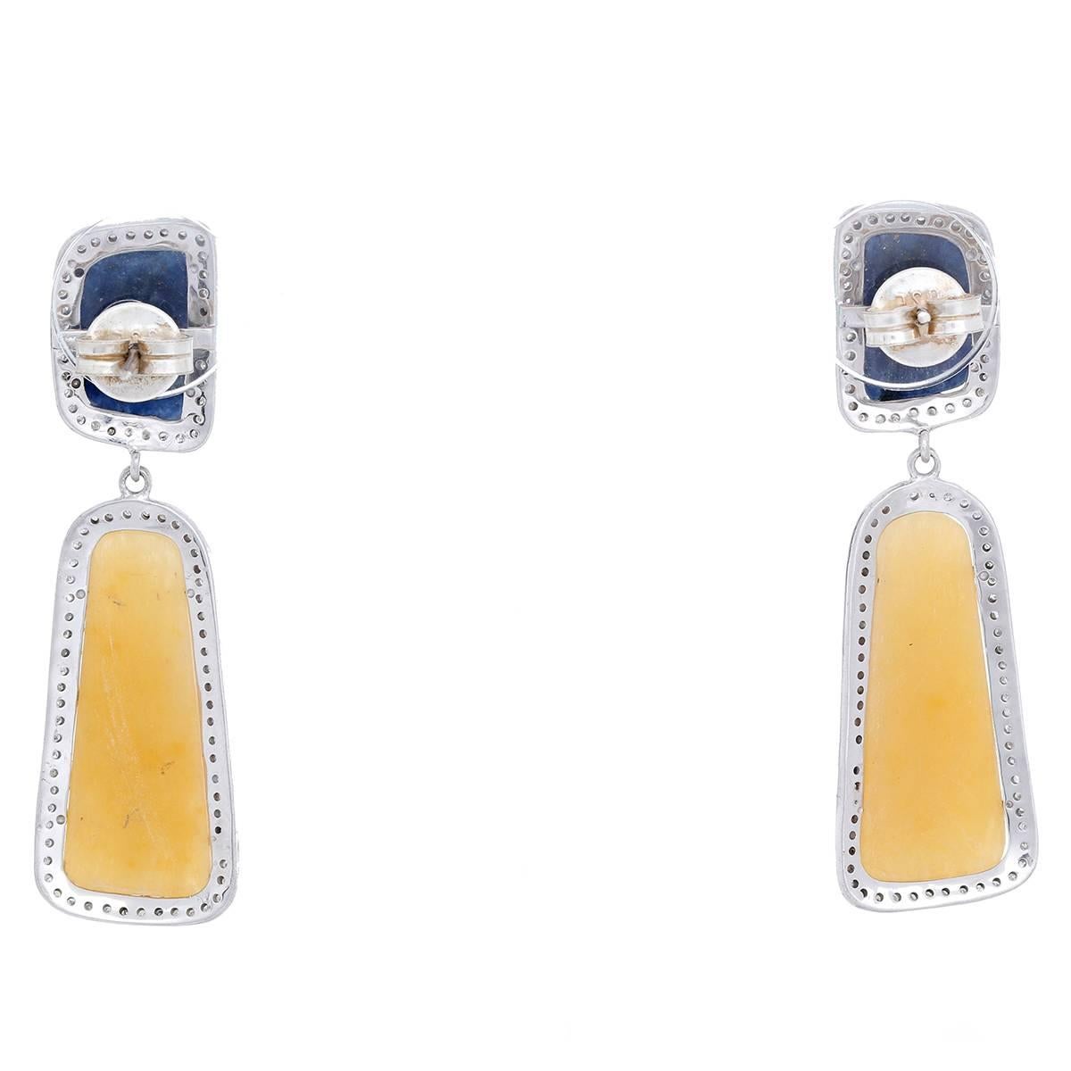 These bohemian inspired earrings feature sapphires and 0.95 ctw. of diamonds set in silver. Total weight is 16.7 grams. Earrings measure apx. 2-1/4 inches in length.