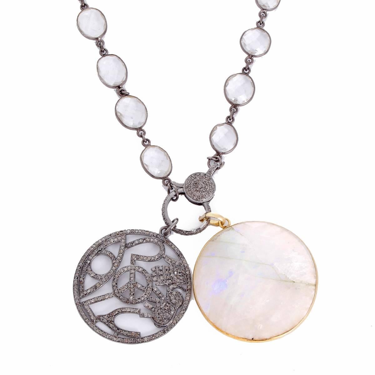 This beautiful necklace features a diamond, moonstone pendant with a diamond clasp on a clear quartz chain. Pendants measure apx. 2-1/8 inches in length at the longest point on a 34-inch chain. Total weight is 74.6 grams.