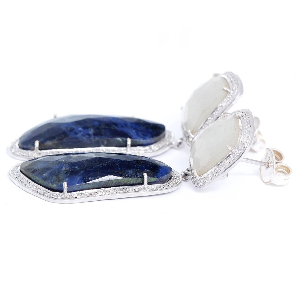 These beautiful earrings feature natural sapphires bordered by 1.7 ctw. of diamonds. Earrings measure apx. 2-3/8 inches in length. Total weight is 18.7 grams.