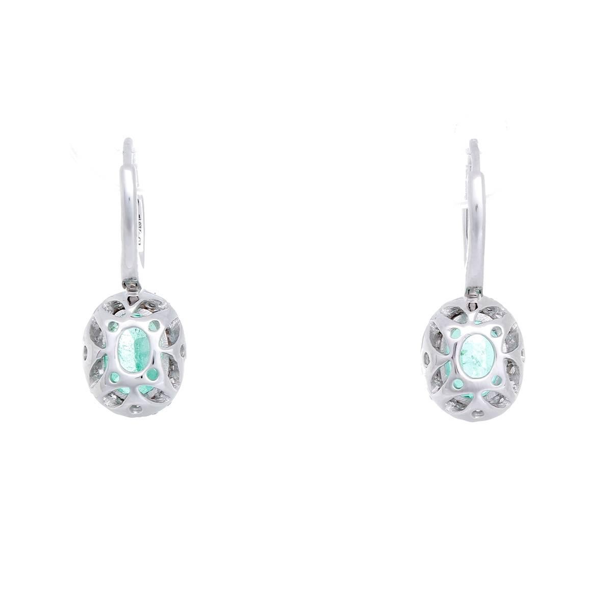 These beautiful earrings feature an oval-cut emerald, with apx. 2.08 ctw., and fifty-two round brilliant-cut diamonds, with apx. 0.41 cts. Earrings measure apx. 1-inch in length. Total weight is 4.0 grams.