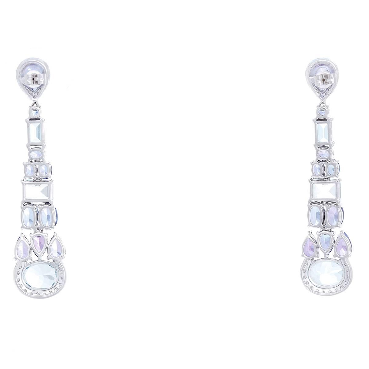 These long dangle earrings feature two oval-cut and four emerald-cut aquamarines, with apx. 6.00 ctw., ten oval-cut, eight pear-cut and two round-cut tanzanites, with an apx. 7.30 ctw., and sixty-six round brilliant-cut diamonds, with apx. 0.45 ctw.