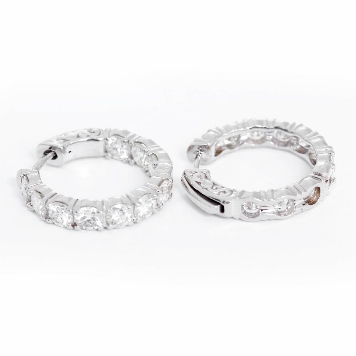 These inside-out style hoop earrings feature 3.94 carats of VS-SI-clarity and H-I-color diamonds set in 14k white gold. Earrings measure apx. 3/4- inch in diameter.  Total weight is 7.3 grams.