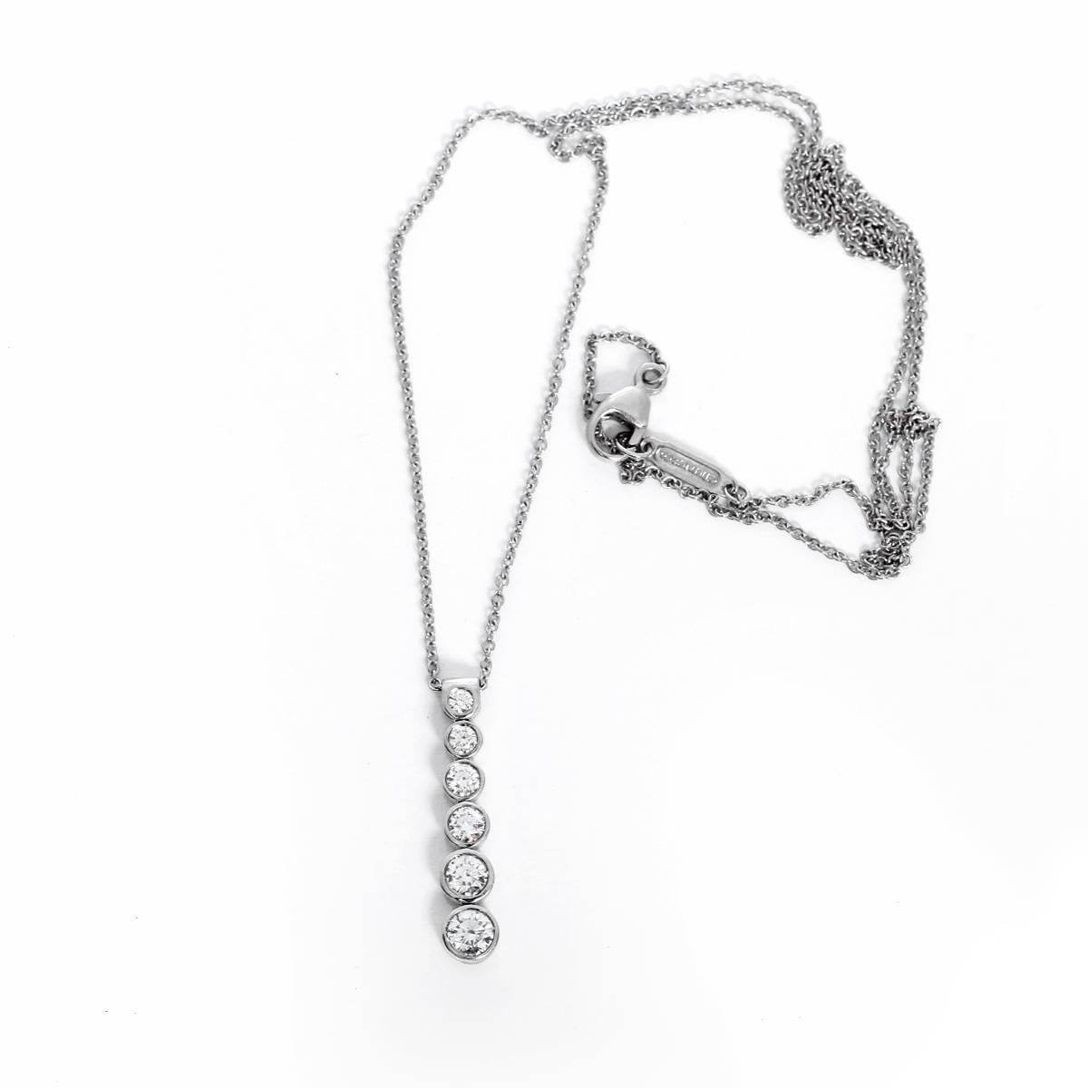 This Tiffany & Co. necklace features a pendant with diamonds set in platinum. Pendant measures apx. 7/8-inch in length on an 18-inch platinum chain. Total weight is 4.8 grams.