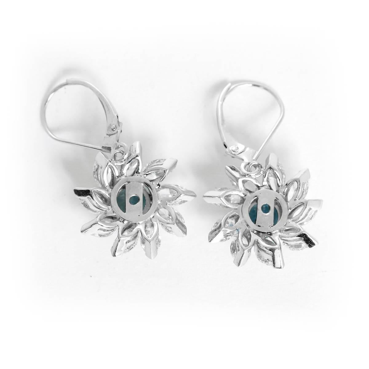 These stunning earrings feature apx. 2.50 carats of aquamarine and apx. 3.0 ctw. of diamonds set in 14k white gold.  Earrings measure apx. 5/8-inch in diameter. Total weight is 5.2 grams.