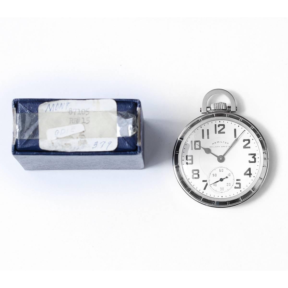 Hamilton Stainless Steel Railway Special Pocket Watch -  Manual winding, 21 jewels. Stainless steel case (50mm). White enamel Hamilton double sunk Montgomery dial, features Art Deco black Arabic hour numerals.. New, old stock with box.Dated from the