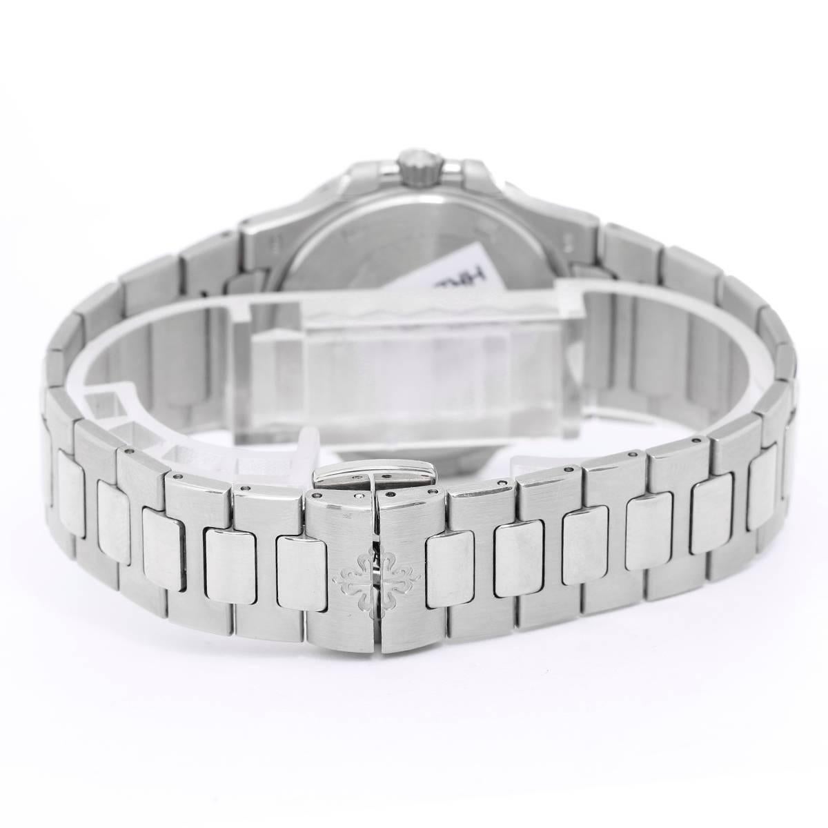 Patek Philippe & Co. Nautilus Ladies 7010 / 1G - 001 -  Quartz. 18K White Gold ( 32mm ) with Diamond bezel. Opaline white dial with gold applied hour markers with luminescent coating. Date at 3 o'clock. 18k white gold bracelet with Nautilus