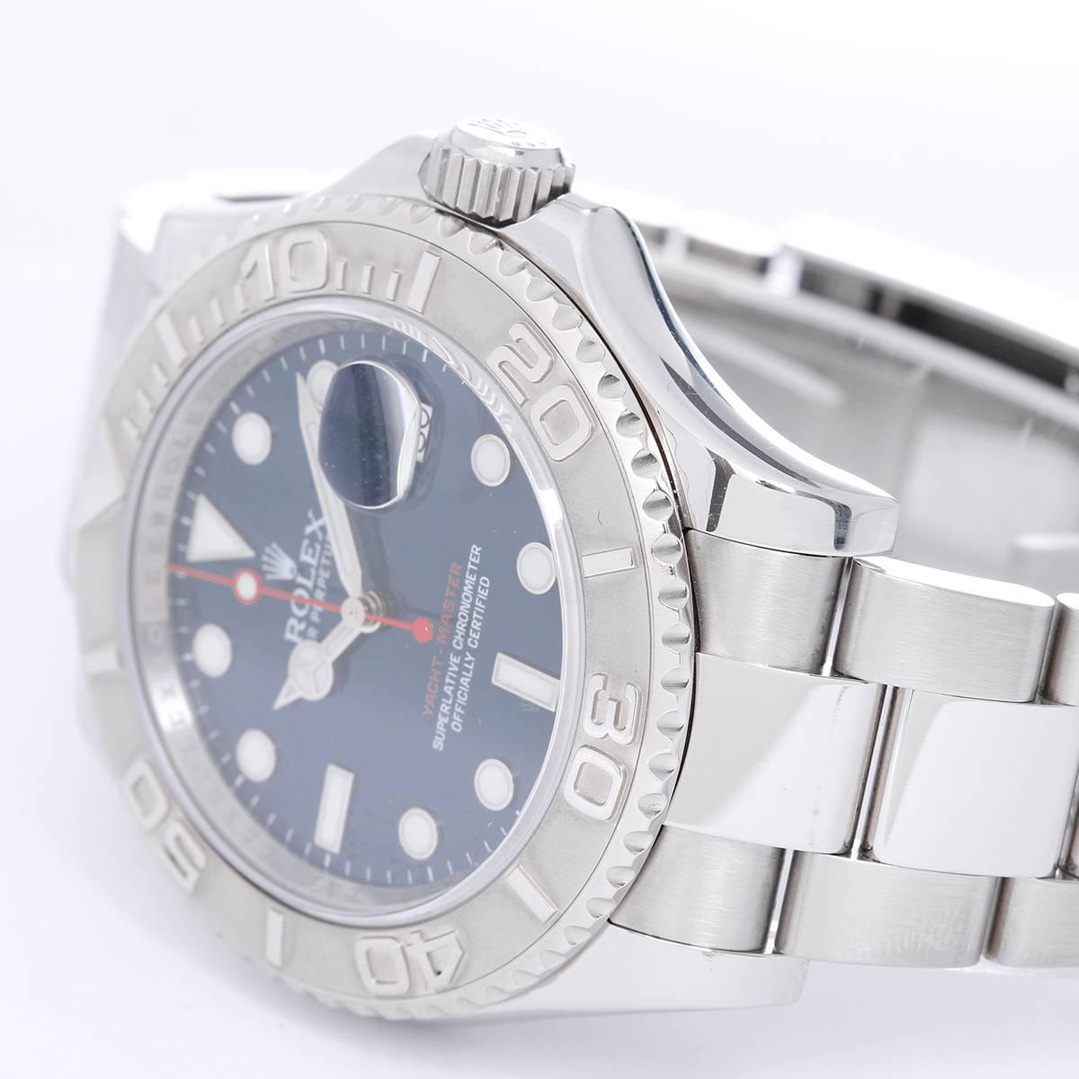 Rolex Yacht-Master Men's Stainless Steel Watch 116622 - Automatic winding, 31 jewels, Quickset, sapphire crystal. Stainless steel case with platinum bezel (40mm diameter). Blue dial with luminous markers. Stainless steel Oyster bracelet with updated
