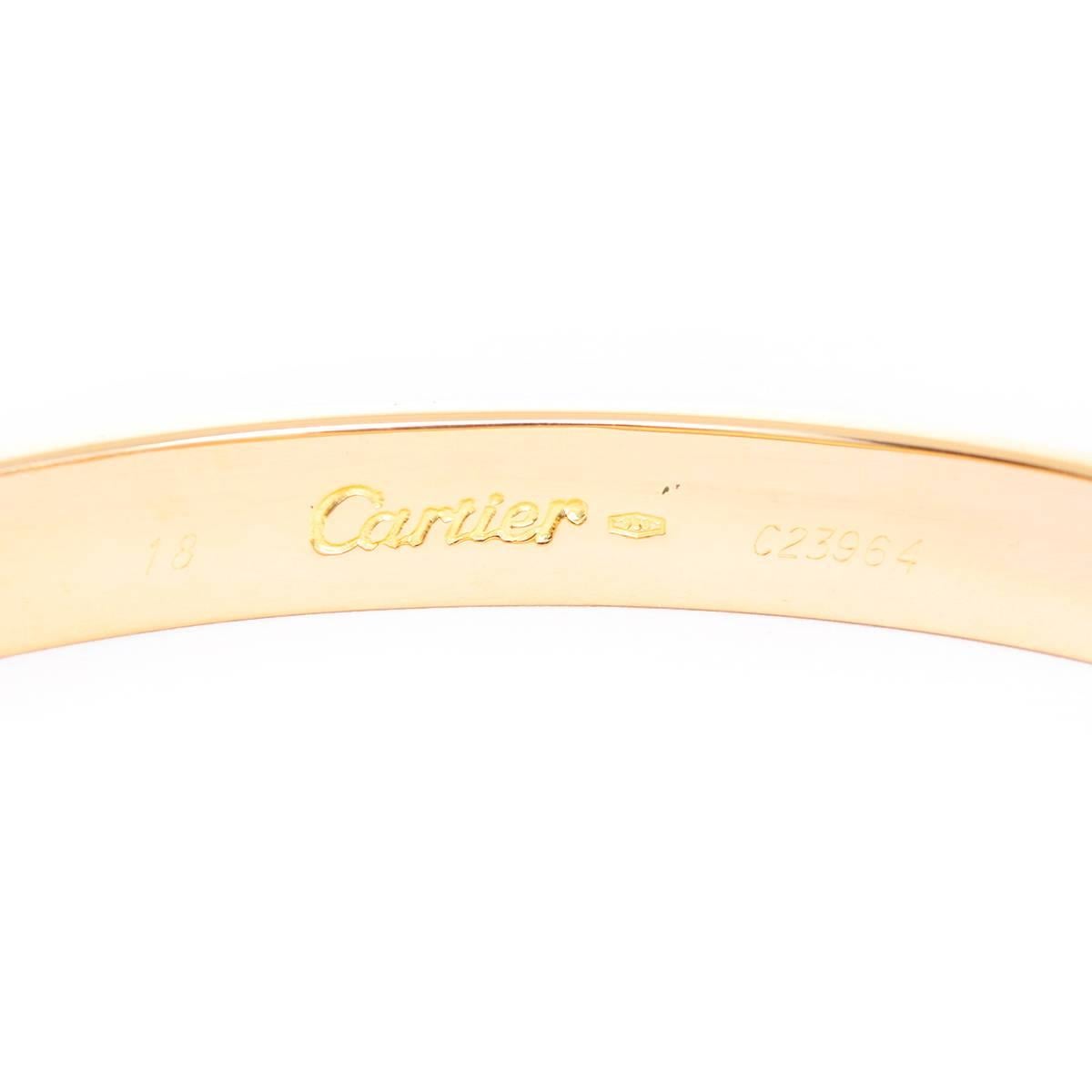 Cartier Love Bracelet 18k Yellow Gold Size 18 with Screwdriver - This beautiful bracelet is stamped Cartier, 18, 750  and C23964.  This is a great piece for everyday as well as dress. Authenticity guaranteed. Like new condition with no dings or