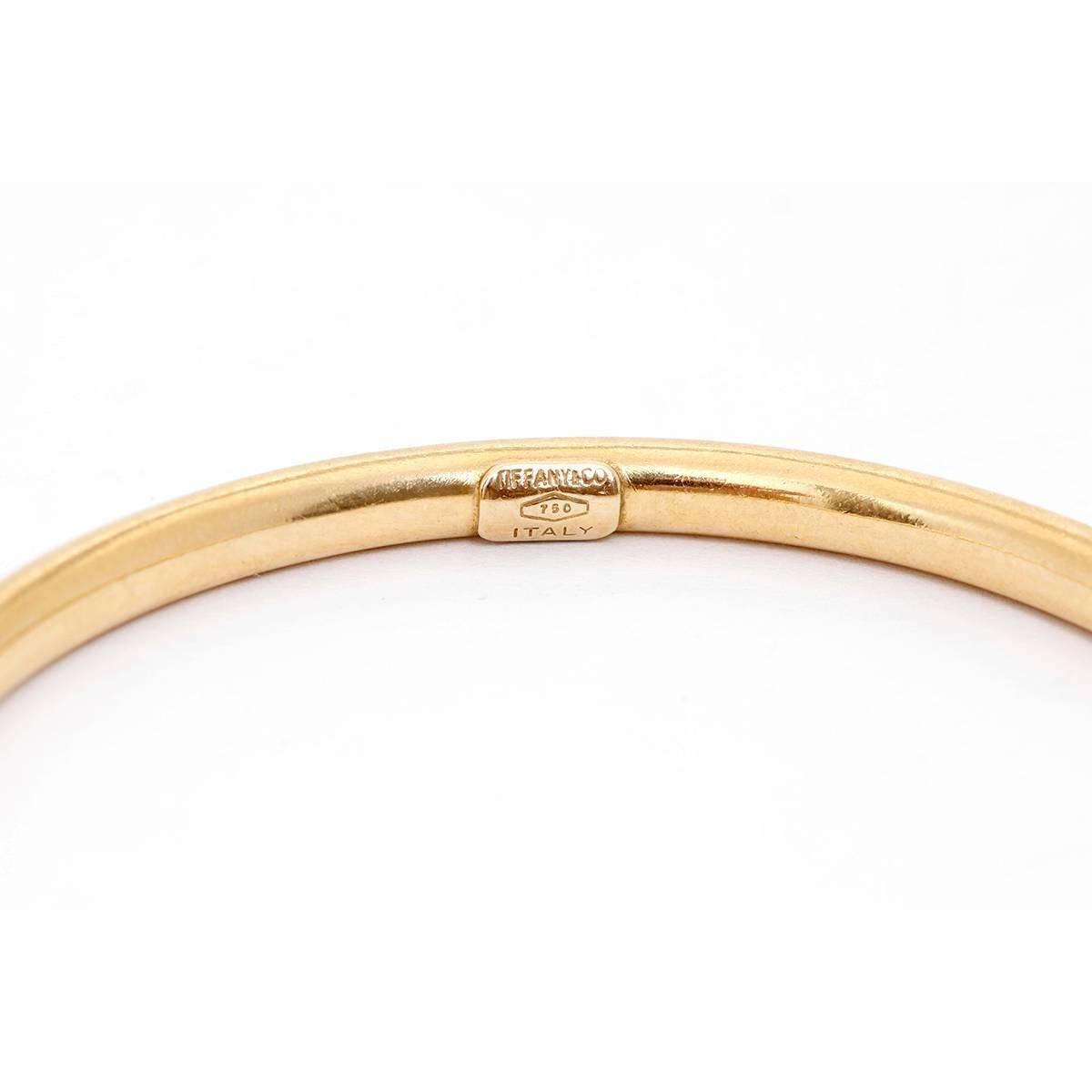Tiffany & co. 14K Yellow Gold Hinged Oval Bangle Size 6 3/4 - . Pre-owned. Inner diamenter 17.1 cm. Size 6 3/4. Hallmarks Tiffany & Co., 585. Total weight 8 grams. Tiffany Estate piece.