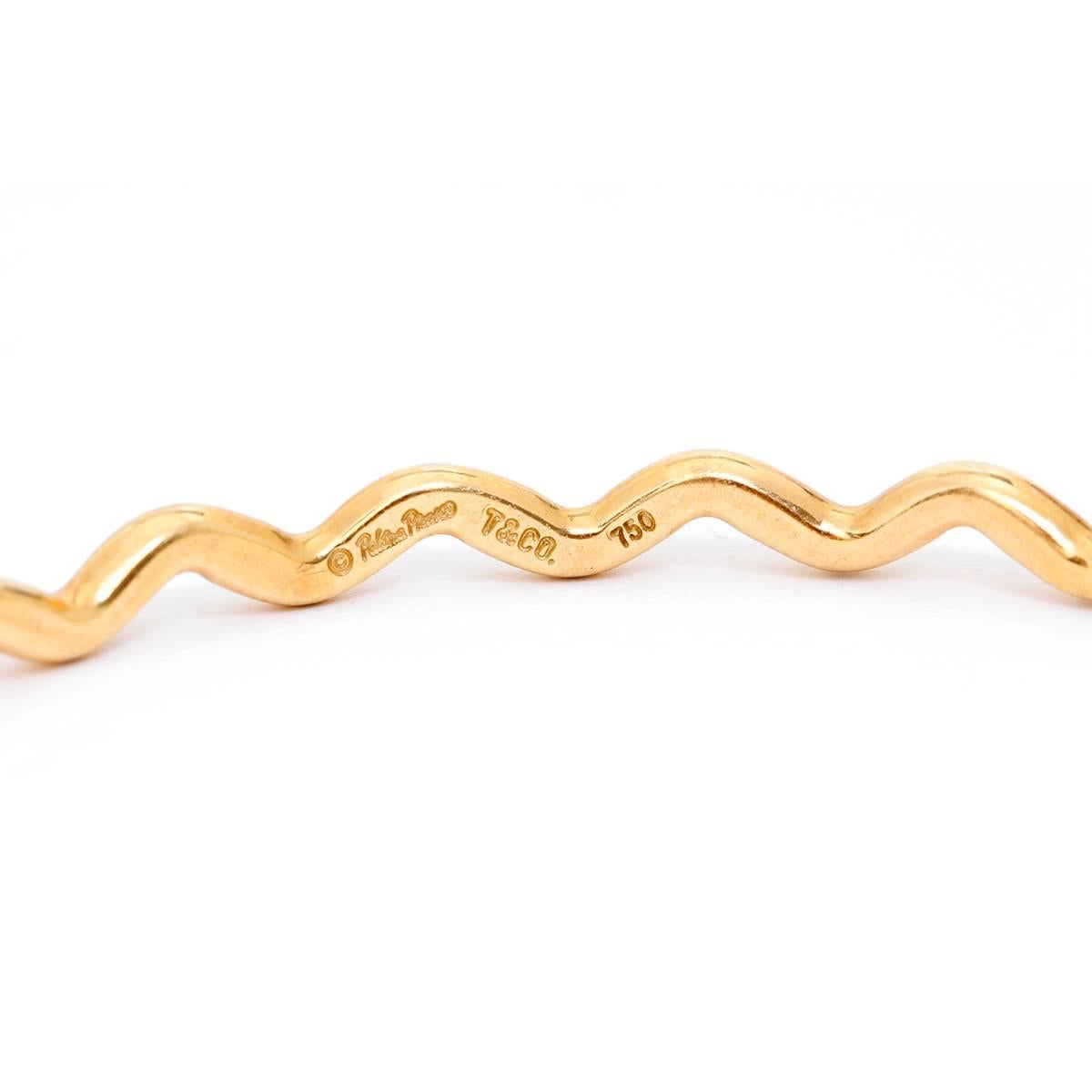 Tiffany & Co. 18K Yellow Gold Squiggle  Banlge Size 8 1/4 - . Pre-owned. Inner diamenter 21 cm. Size  8 1/4. Hallmarks - Tiffany  & Co., 750, Paloma Picasso. Total weight 21.4  grams.